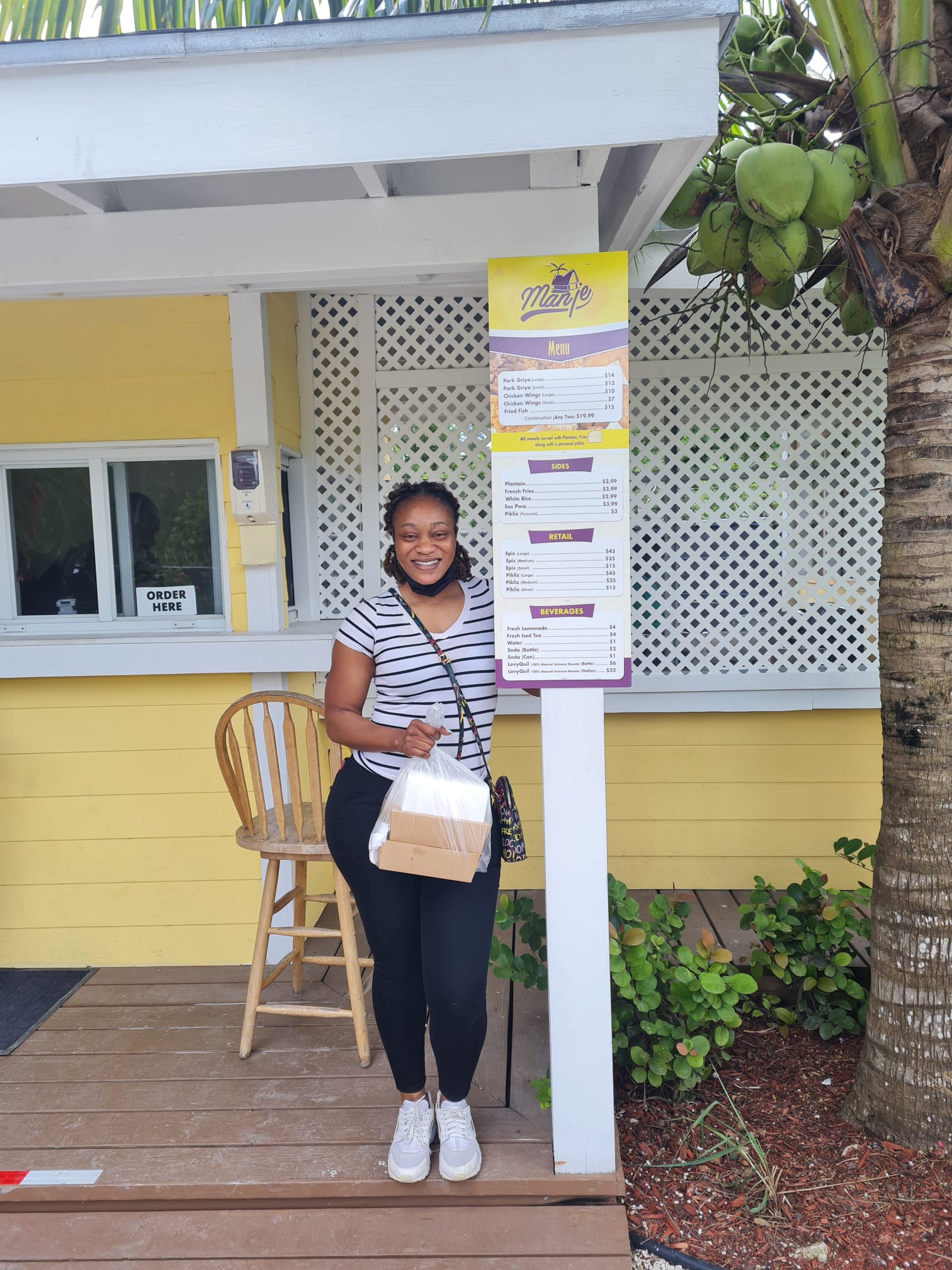 Manje customer with a take-out box